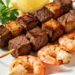 Air fryer steak and shrimp kabobs with juicy grilled beef, tender shrimp, and golden roasted vegetables