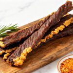 Homemade air fryer beef jerky strips with a rich savory seasoning and chewy texture