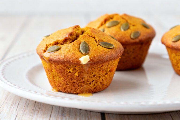 Soft air fryer pumpkin muffins topped with pumpkin seeds and baked until golden and fluffy