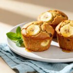 Moist air fryer banana muffins topped with fresh banana slices and baked until golden brown
