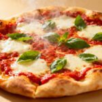 Air fryer naan pizza topped with melted mozzarella cheese, rich tomato sauce, and fresh basil leaves