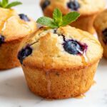 Soft air fryer blueberry muffins packed with juicy blueberries and finished with a light honey drizzle