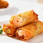 Crispy air fryer shrimp egg rolls filled with juicy shrimp and savory vegetables wrapped in a golden shell