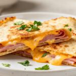 Crispy air fryer ham and cheese wraps filled with savory ham and melted cheddar cheese