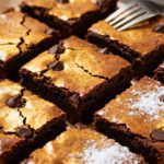 Fudgy air fryer box brownies with crackly tops, rich chocolate flavor, and chocolate chips throughout