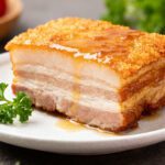 Crispy air fryer pork belly with crackling skin, juicy layers of meat, and rich savory flavor
