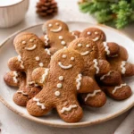 Gingerbread cookies with white icing decorations served on a festive holiday plate