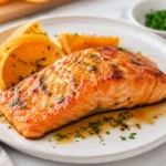 Juicy air fryer orange salmon fillet glazed with citrus sauce and served with fresh orange slices
