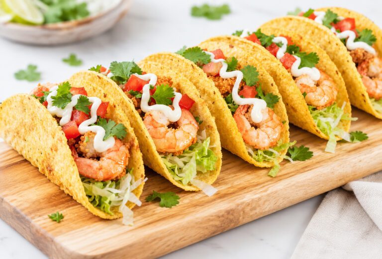 Crispy air fryer shrimp tacos filled with seasoned shrimp, fresh lettuce, tomatoes, and creamy sauce