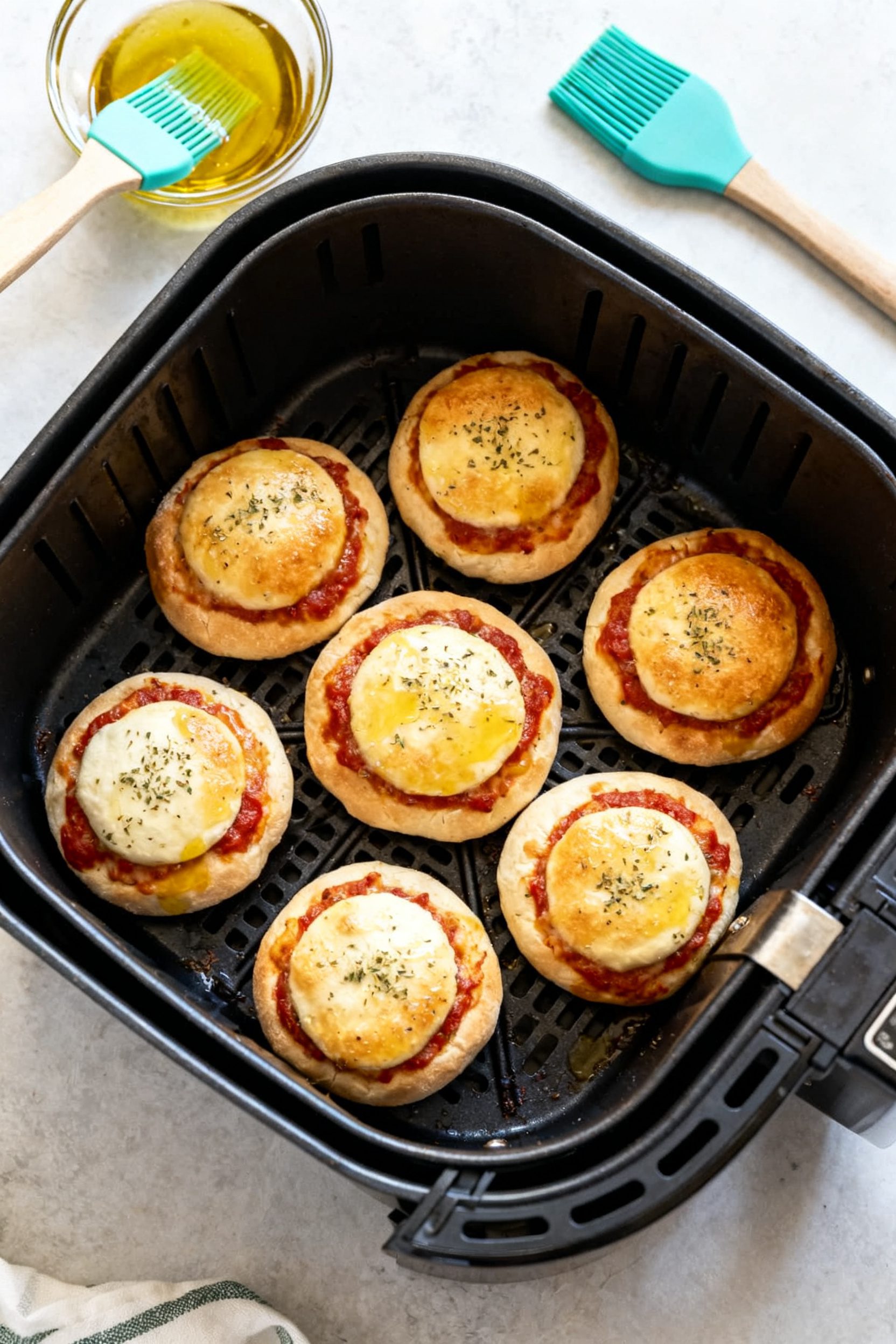 Cooking process: Air Fryer Pizza Balls arranged in a single layer in the air fryer basket with space