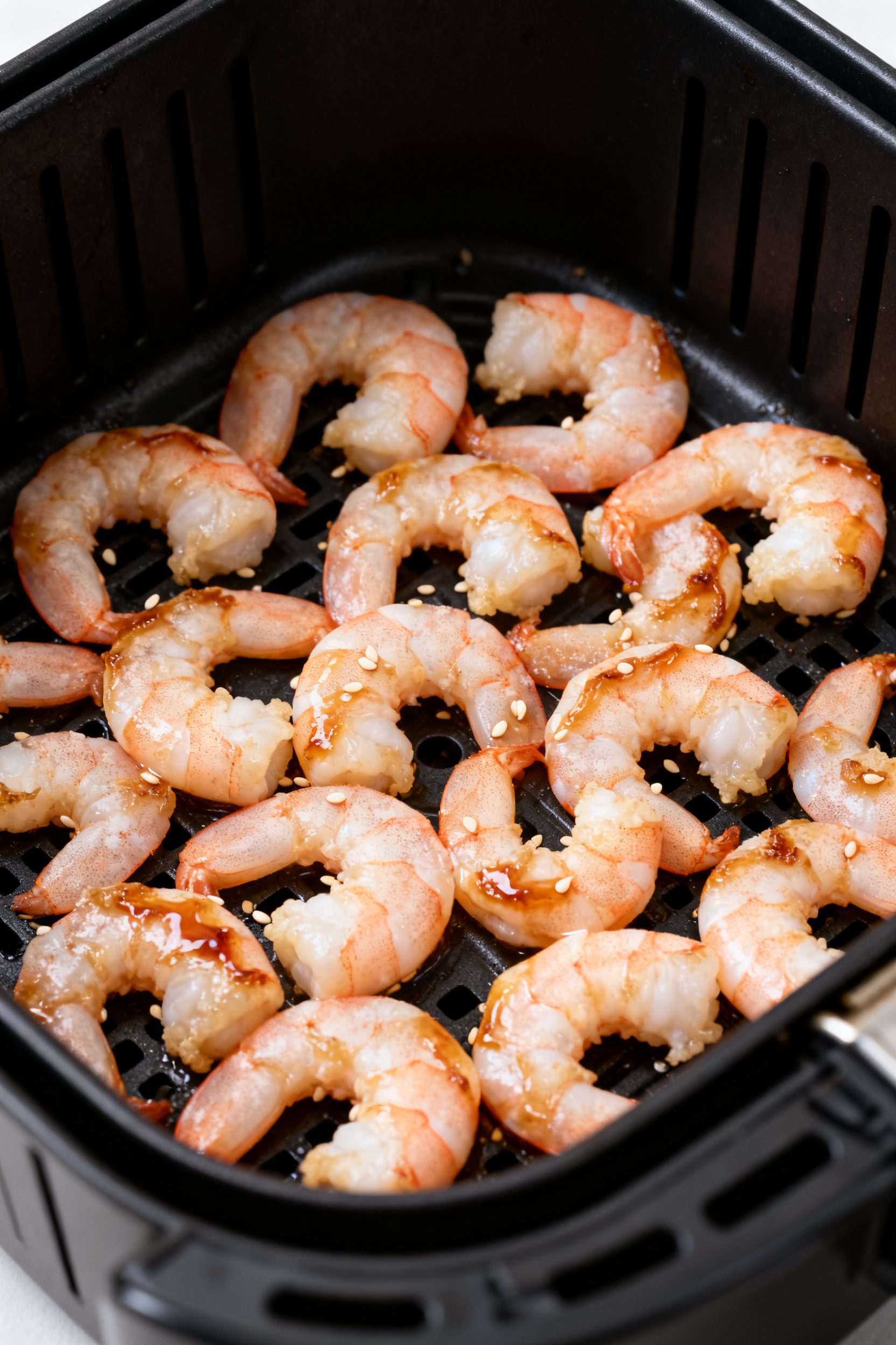 Cooking process close-up: Air fryer basket at 400°F with a single, uncrowded layer of marinated shr