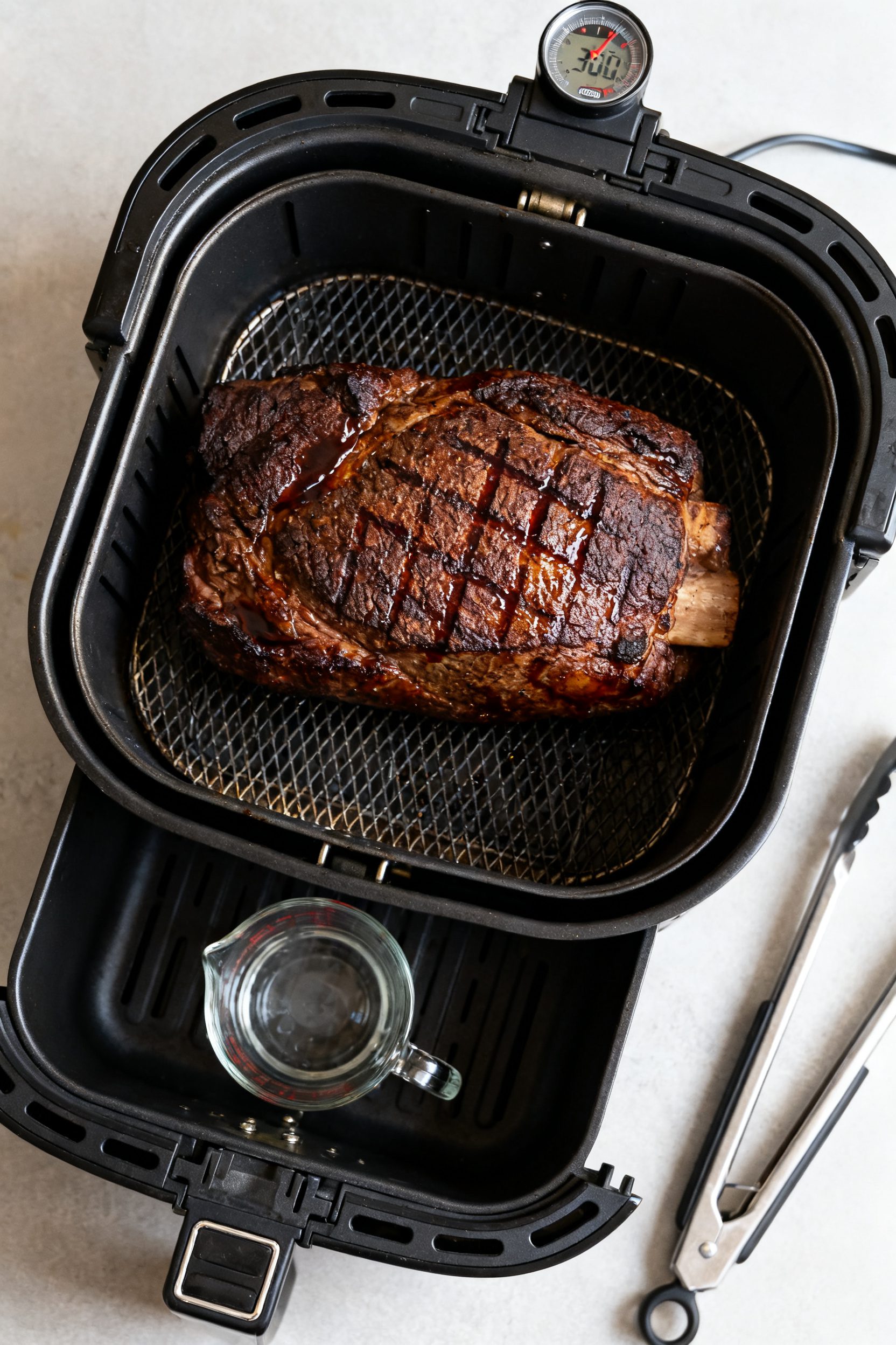 Cooking process: Overhead shot of the cooked roast in the open air fryer basket at 360°F, post-flip