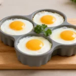 Air fryer silicone egg mold recipe with perfectly cooked eggs in a reusable silicone mold, featuring set whites and bright yolks for an easy high protein breakfast.