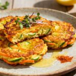 Crispy air fryer zucchini carrot fritters made with shredded zucchini and carrots, pan golden and served with lemon