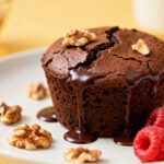 Air fryer brownie for one with a fudgy chocolate center, melted chocolate drizzle, walnuts, and fresh raspberries