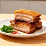 Asian style air fryer pork belly with crispy crackling skin, juicy layers of pork, and savory flavor