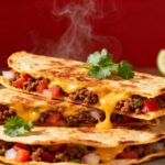 Air fryer ground beef quesadillas with seasoned beef, melted cheddar cheese, peppers, and crispy golden tortillas