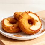 Air fryer apple ring donuts coated with cinnamon sugar and made with fresh apple slices and golden donut batter