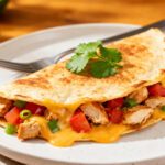 Air fryer chicken quesadilla with juicy chicken, melted cheddar cheese, peppers, and a crispy golden tortilla