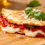 Air fryer pizza quesadilla with melted mozzarella cheese, rich pizza sauce, parmesan, and crispy golden tortillas