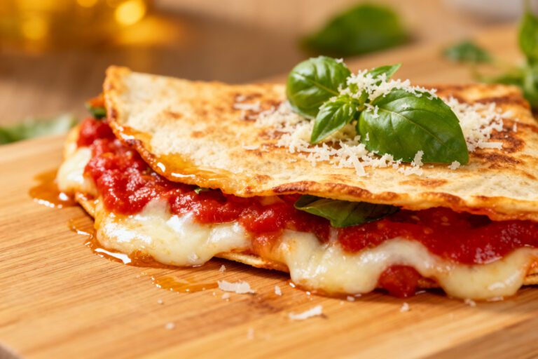 Air fryer pizza quesadilla with melted mozzarella cheese, rich pizza sauce, parmesan, and crispy golden tortillas