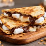 Air fryer smores quesadilla filled with melted chocolate, gooey marshmallows, and crispy golden tortillas