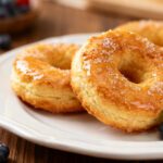 Air fryer biscuit donuts with a soft fluffy center, sweet glaze, and golden homemade bakery style texture