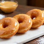 Air fryer glazed donuts with a soft fluffy texture and a sweet vanilla glaze coating every bite