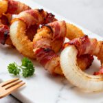 Air fryer bacon wrapped onion rings with crispy bacon, sweet tender onions, and a perfectly roasted finish
