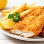 Air fryer fish and chips tilapia with crispy golden breaded fish, crunchy fries, and fresh lemon wedges