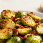 Air fryer Brussels sprouts with bacon featuring crispy roasted sprouts, smoky bacon pieces, and caramelized edges