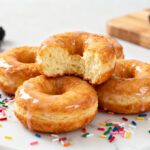 Air fryer canned biscuit donuts with a soft fluffy center, sweet glaze, and golden homemade texture