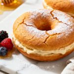 Air fryer protein donuts with a soft fluffy texture, creamy protein filling, and a light dusting of powdered sugar