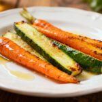 Air fryer carrots and zucchini roasted until tender with lightly caramelized edges, drizzled with glaze and served as a simple and flavorful vegetable side dish.