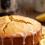 Air fryer lemon drizzle cake with a moist golden crumb and sweet lemon glaze, served with fresh lemon slices and a bright citrus flavor.