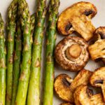Air fryer steak and veggies with a juicy grilled steak, roasted baby potatoes, carrots, and Brussels sprouts, served with a savory pan sauce and fresh rosemary.