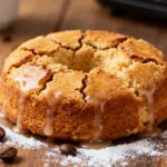 Air fryer coffee cake with a soft cinnamon swirled crumb, sweet glaze drizzle, and golden brown topping, served with coffee beans for a cozy homemade dessert.