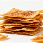 Air fryer cinnamon sugar chips with a light crispy texture, coated in cinnamon and sugar, stacked into crunchy layers for a sweet and irresistible snack.