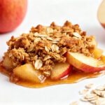 Air fryer apple crisp with oats featuring tender cinnamon apples, a crunchy oat streusel topping, and a sweet caramelized sauce for a cozy homemade dessert.