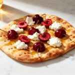 Air fryer cherry ricotta flatbread topped with creamy ricotta cheese, fresh cherries, and a sweet honey drizzle on a golden baked flatbread crust.