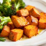 Air fryer broccoli and sweet potatoes with tender roasted broccoli florets and golden sweet potato cubes, lightly seasoned and drizzled with oil, served as a colorful and flavorful side dish.