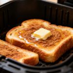 Cinnamon sugar toast in the air fryer with golden buttery bread, a sweet cinnamon sugar topping, melted butter, and crisp toasted edges, cooked inside an air fryer basket.
