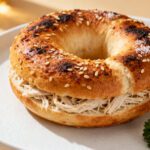 High protein Greek yogurt bagel made in the air fryer with a chewy golden crust, toasted sesame seed topping, and protein packed texture, served as a satisfying breakfast or snack.