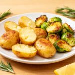 Air fryer potatoes and Brussels sprouts with crispy roasted baby potatoes, caramelized Brussels sprouts, fresh rosemary, and lemon accents, served as a flavorful and easy vegetable side dish.