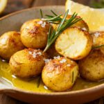 Petite potatoes cooked in the air fryer with crispy golden skins, fluffy tender centers, flaky sea salt, fresh rosemary, lemon wedges, and a drizzle of olive oil, served as an easy weeknight side dish.