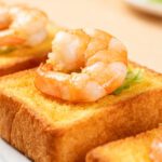 Air fryer shrimp toast with crispy golden toasted bread, tender juicy shrimp, and a light savory topping, served as a quick appetizer or snack with a crunchy texture and seafood flavor.