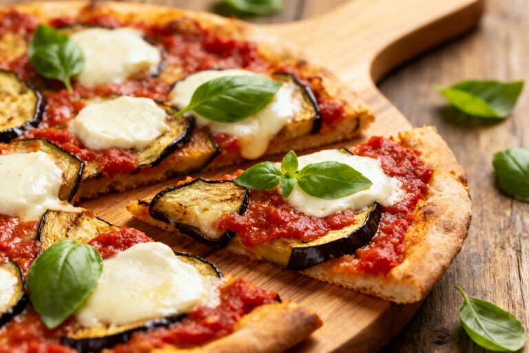Air fryer eggplant pizza with crispy pizza crust, roasted eggplant slices, rich tomato sauce, melted mozzarella cheese, and fresh basil leaves, served as a satisfying vegetarian meal.