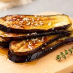Air fryer Japanese eggplant with tender roasted eggplant slices, a glossy savory glaze, toasted sesame seeds, and caramelized edges, served as a flavorful Asian inspired vegetable side dish.