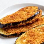 Air fryer breaded eggplant slices with a crispy golden breadcrumb coating, tender creamy eggplant inside, and lightly browned edges, served as an easy vegetarian appetizer or side dish.
