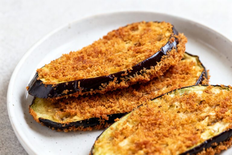 Air fryer breaded eggplant slices with a crispy golden breadcrumb coating, tender creamy eggplant inside, and lightly browned edges, served as an easy vegetarian appetizer or side dish.
